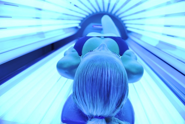 While a tanning bed might cause herpes to show up, it's most likely that you carried it all along and didn't know it.